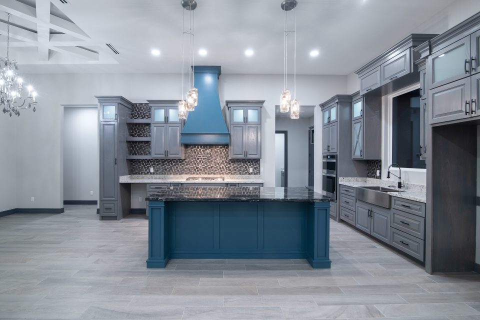 A kitchen with a center island and a counter top.