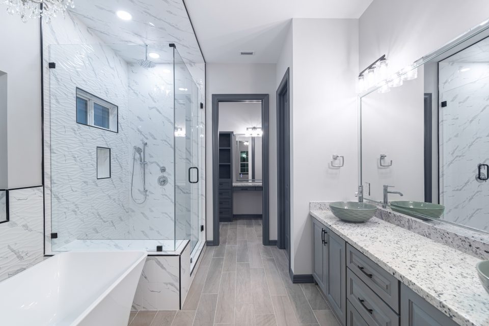 A bathroom with a large mirror and a sink