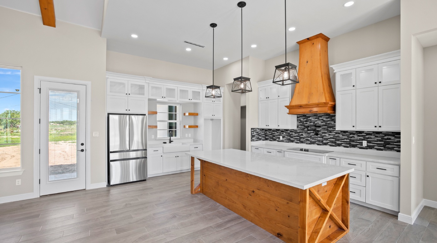 a large kitchen with a center island in the middle of the room