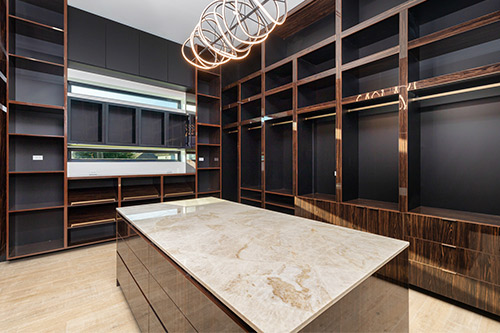 A stylish walk-in closet featuring a sleek marble countertop, showcasing modern home design trends for the RGV area in 2026.