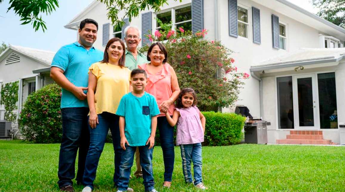Family in front of a beautiful house