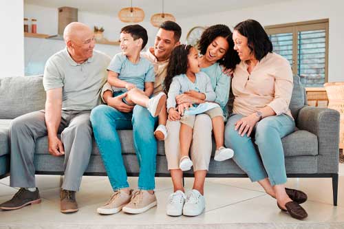 A happy family gathered on a couch, sharing a moment of togetherness and laughter.